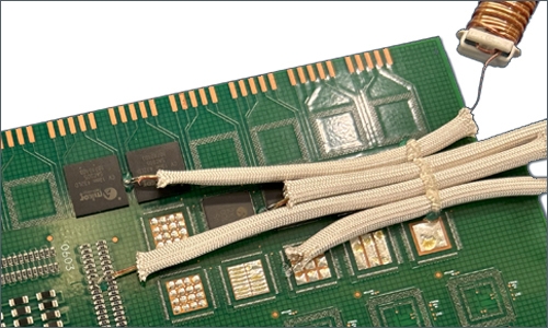 A thermocouple sleeve is secured to a printed circuit board with Dymax 9037-F adhesive.